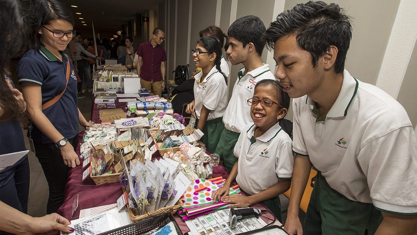 indian students selling items at a booth
