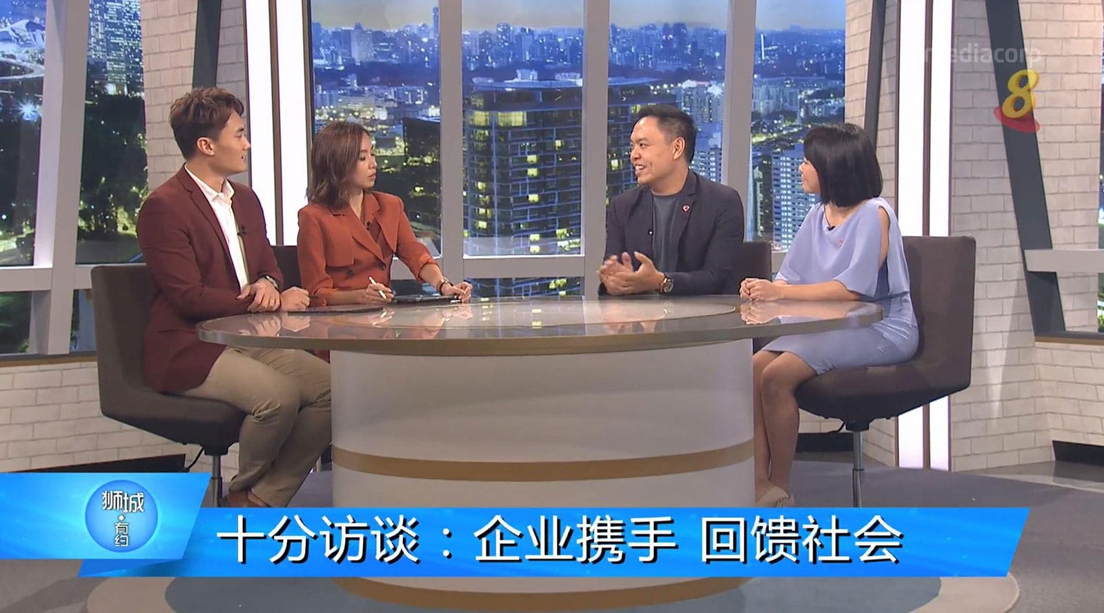 screengrab of chinese news report four people discussing