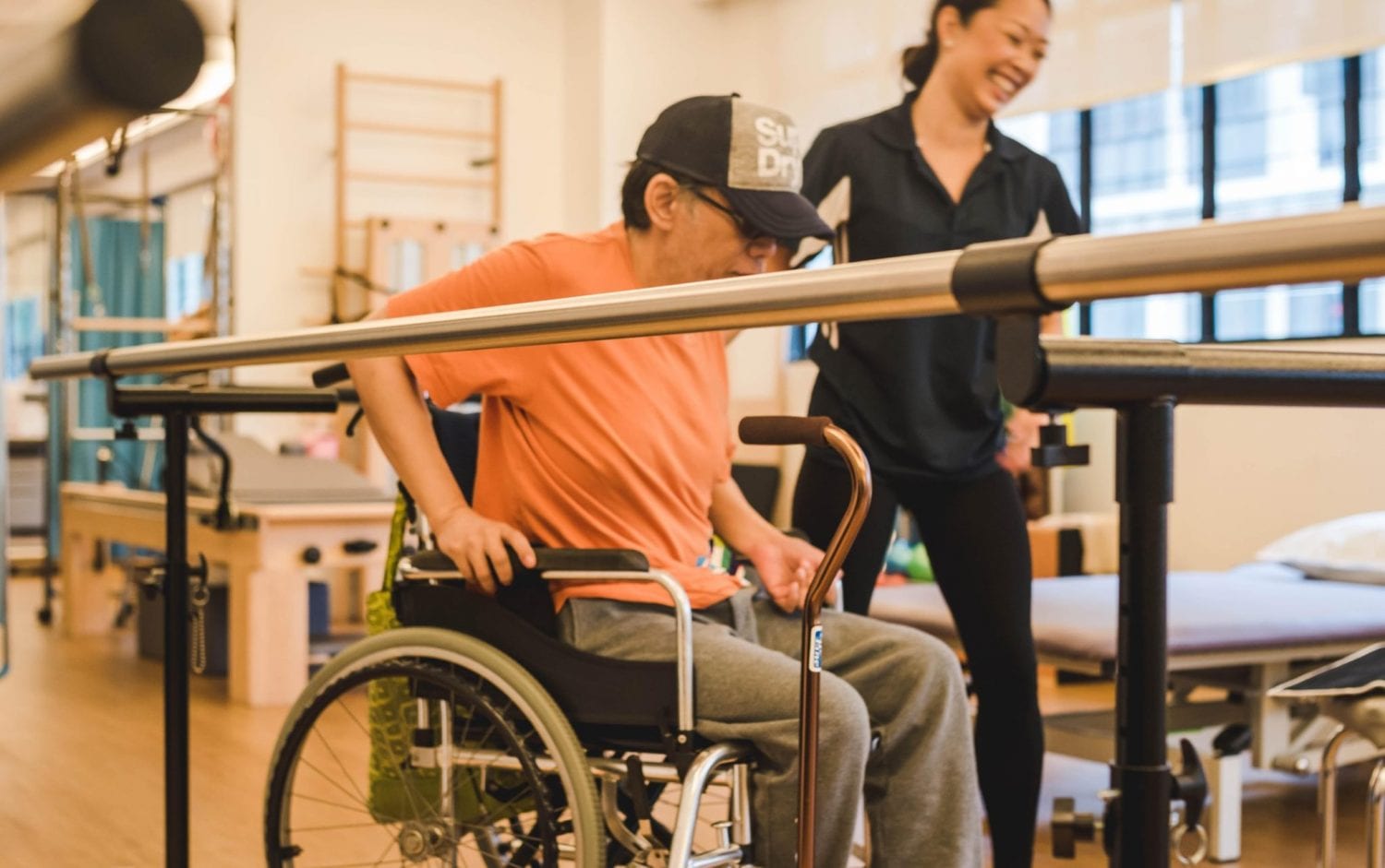 man in orange shirt and wheelchair at physiotherapy