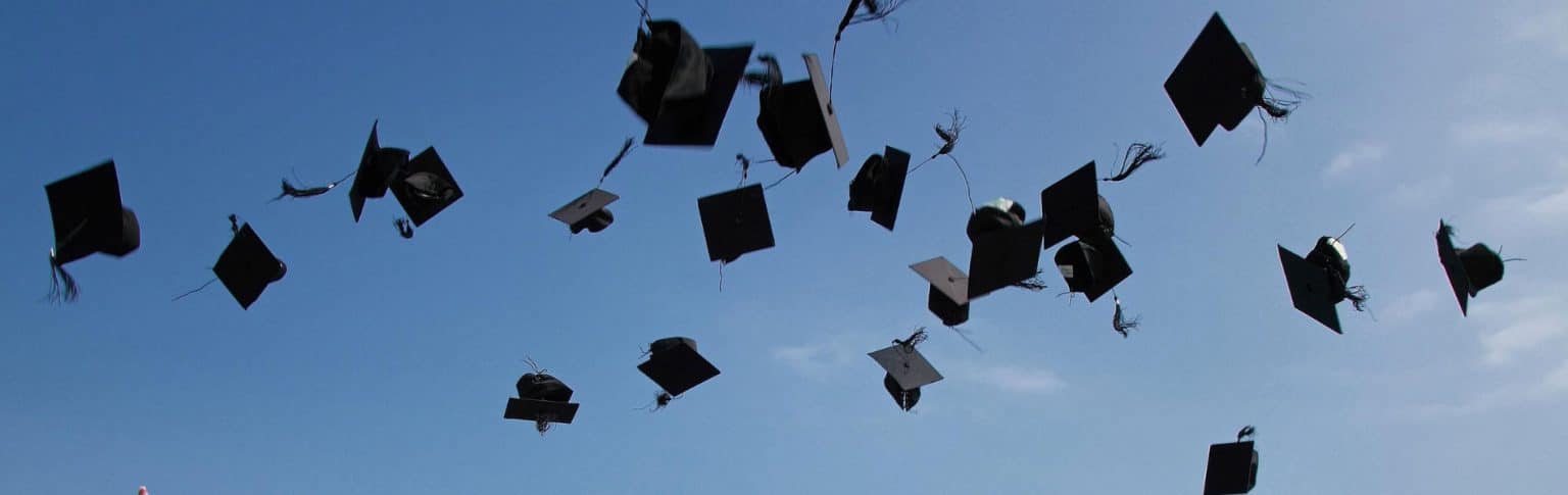 graduation caps being thrown into the air