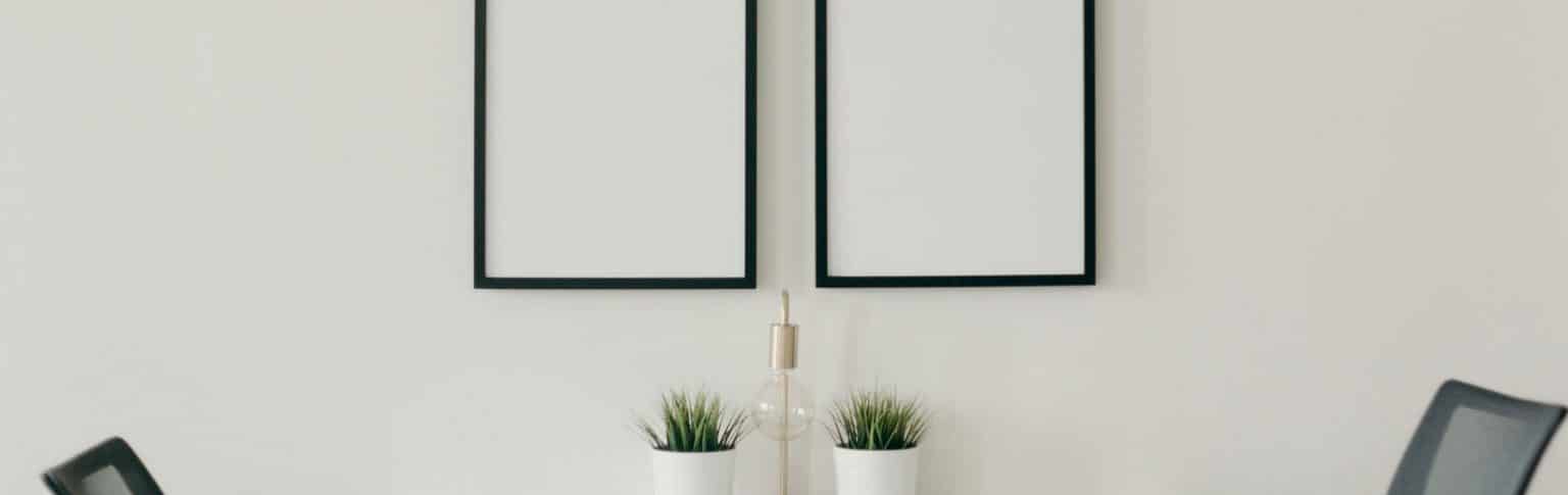 two black picture frames on white wall