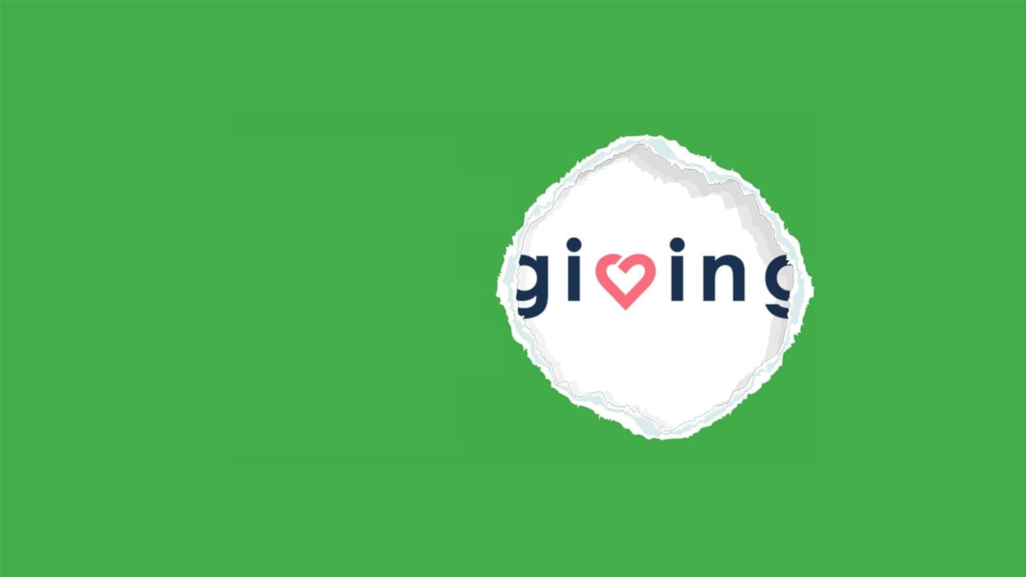giving.sg logo behind torn green screen