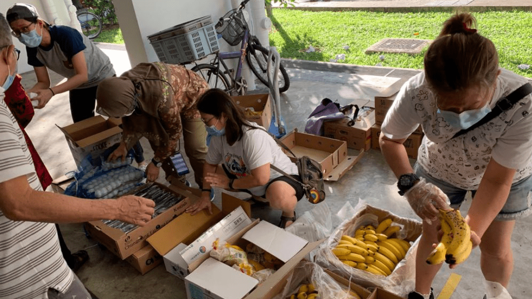 volunteers at food rescue sengkang handing out bananas and eggs
