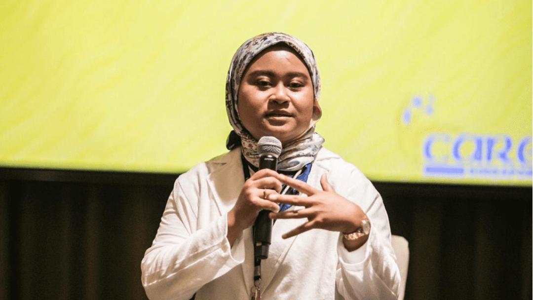woman in headscarf giving a talk